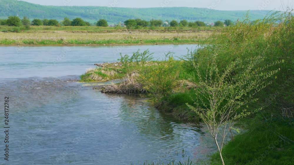 Beautiful river for fishing with grassy shore Beautiful river for fishing with grassy shore