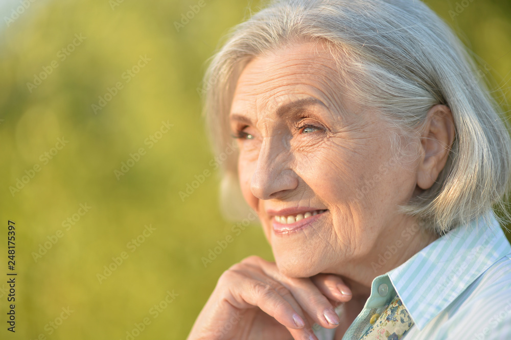 Portrait of beautiful elderly woman posing outdoors Portrait of beautiful elderly woman posing outdoors