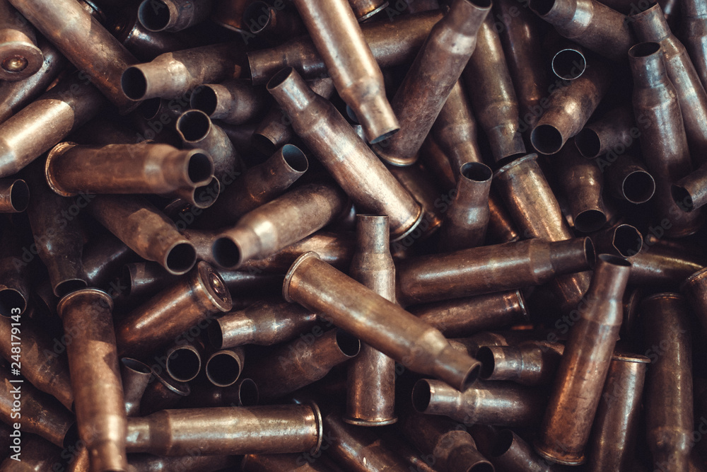 pile of used rifle cartridges 7.62 mm caliber, many empty bullet shells, assault rifle bullet shell, military background, top view pile of used rifle cartridges 7.62 mm caliber, many empty bullet shells, assault rifle bullet shell, military background, top view