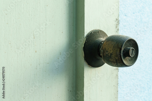 Rusty knob on wooden door