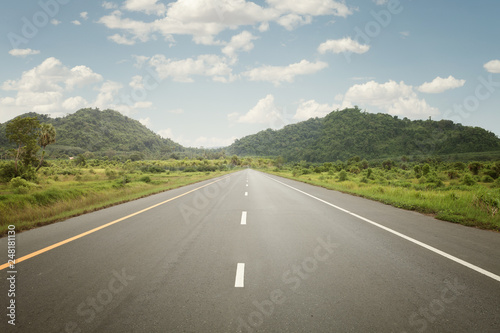 panoramic view of hot summer road with green trees around