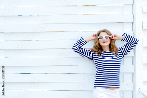 The girl in front of a white wall copy space