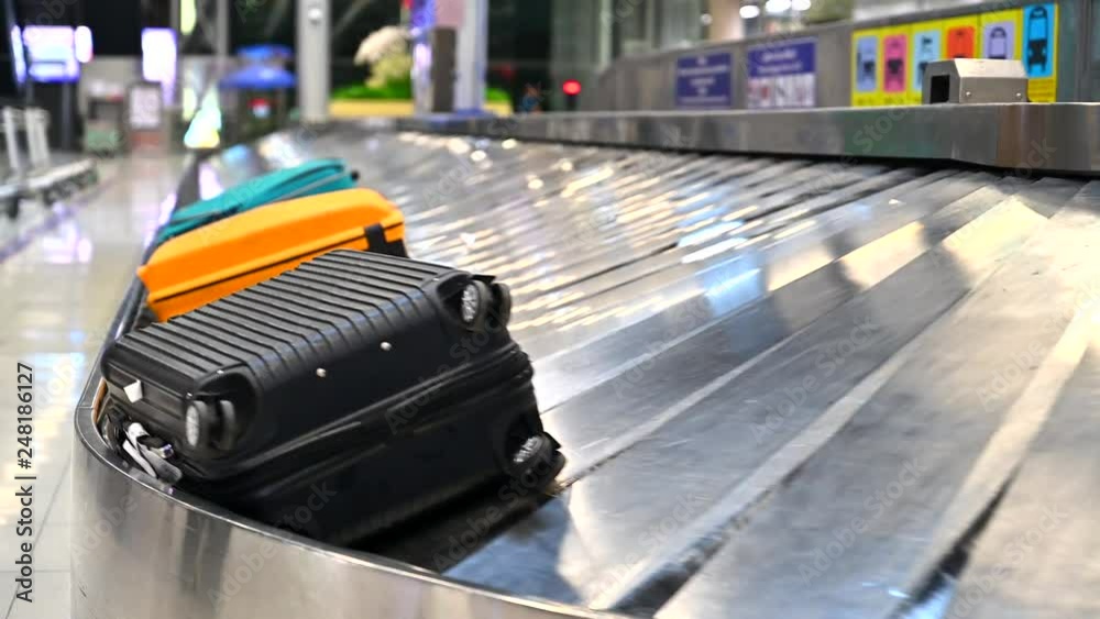 Various suitcases on conveyor belt in the international airport