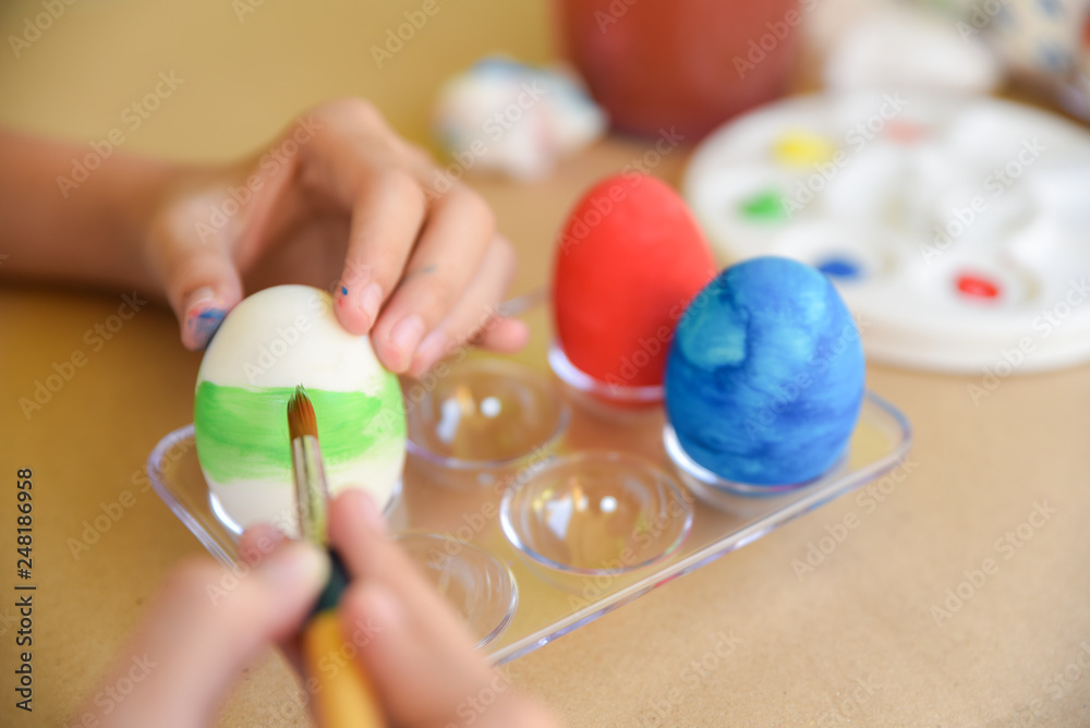 Happy Easter Day. Easter eggs concept. Close up of little girl coloring eggs for Easter. Happy family preparing eggs for Easter. Happy Easter Day. Easter eggs concept. Close up of little girl coloring eggs for Easter. Happy family preparing eggs for Easter.