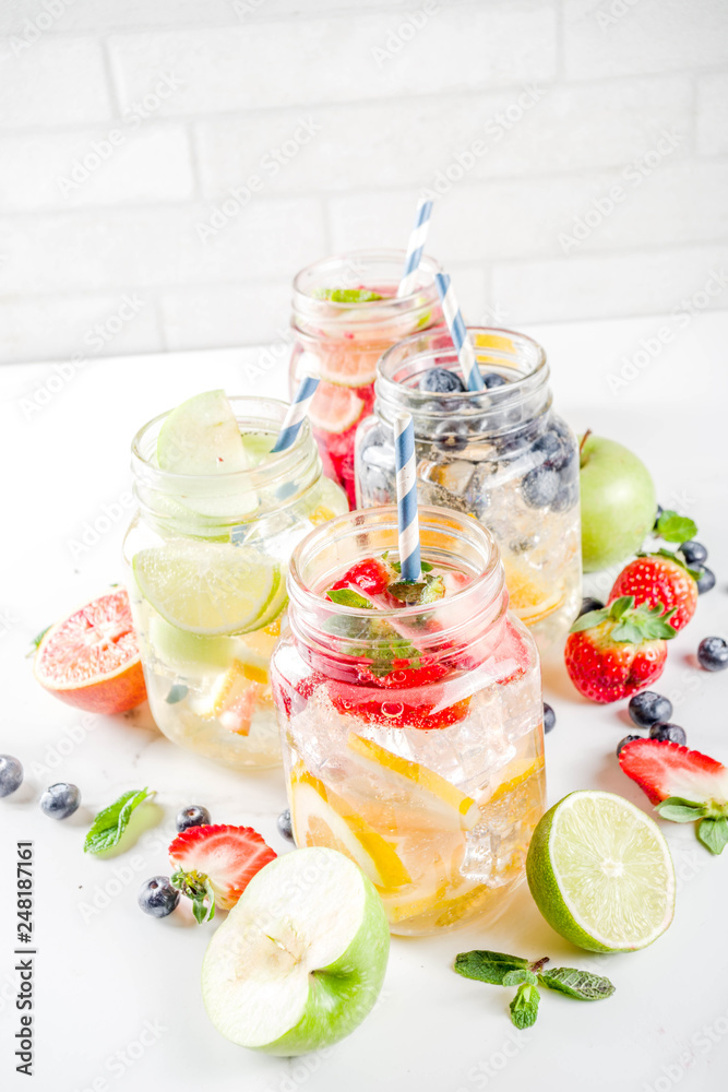 Selection various fruit and berry lemonade drinks, refreshment infused water, in mason jars, with fresh strawberry, lemon, lime, oranges, blueberry, copy space Selection various fruit and berry lemonade drinks, refreshment infused water, in mason jars, with fresh strawberry, lemon, lime, oranges, blueberry, copy space