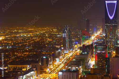 Panorama view to the skyline of Riyadh by night, with the Kingdom centre in the background and blue lighting, the capital of Saudi Arabia photo