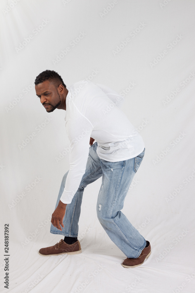 Thoughtful man kneeling Stock Photo | Adobe Stock