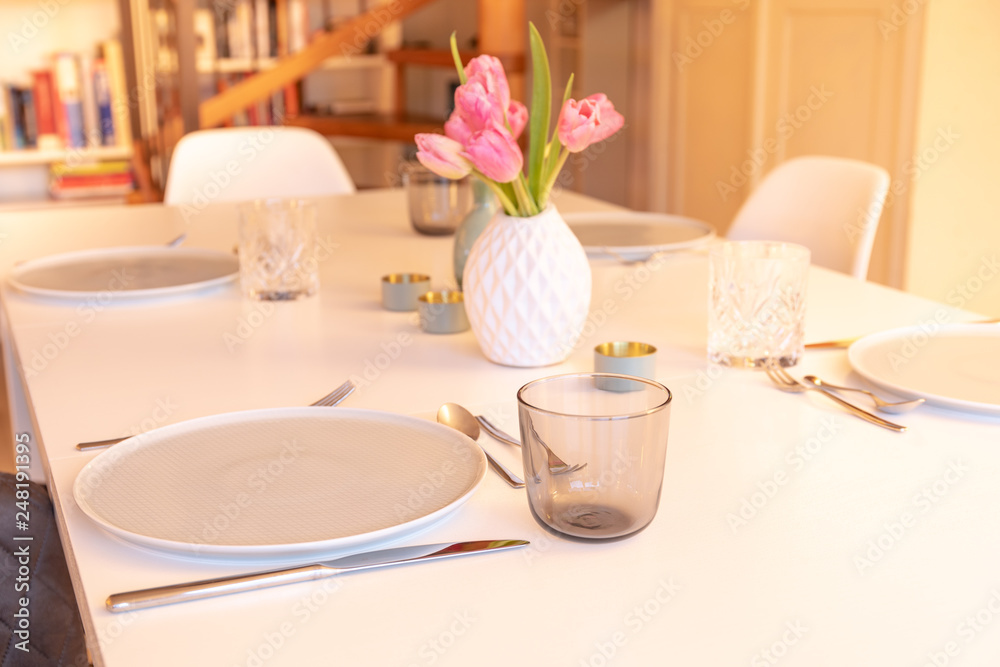 Fototapeta premium Decorated Table with Tulips, Plates and Glasses
