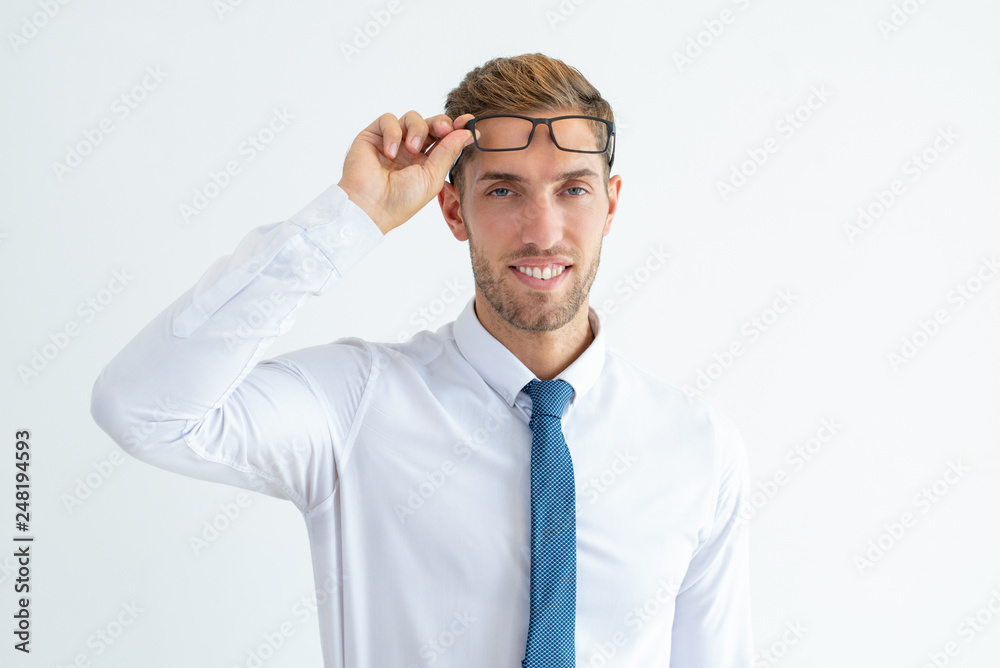 Happy young business man raising glasses
