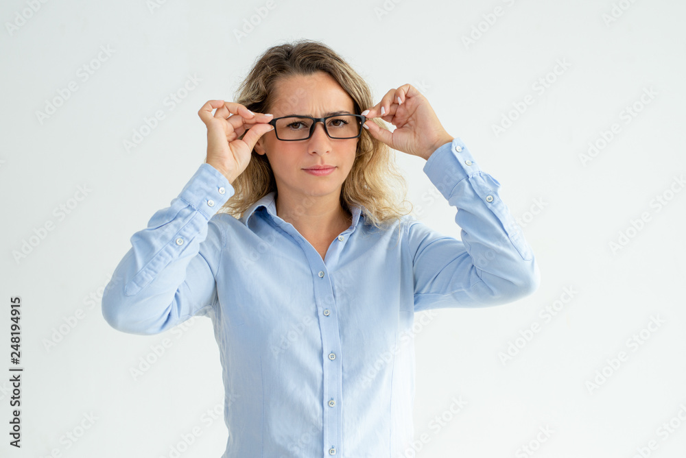 Focused frowning office girl staring at camera Focused frowning office girl staring at camera