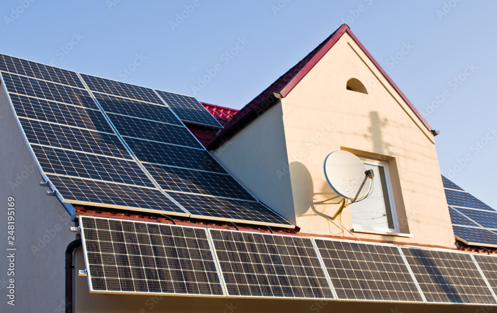 Fototapeta premium Solar panels on red tin roof
