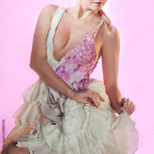 delicate girl in pink dress on pink background