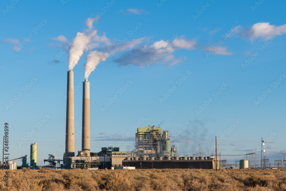 A coal-fired electrical power plant with smokestacks emitting plumes of smoke in the southwestern United States A coal-fired electrical power plant with smokestacks emitting plumes of smoke in the southwestern United States