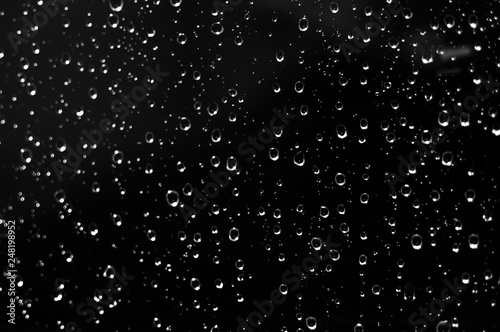 Droplets of water on black glass