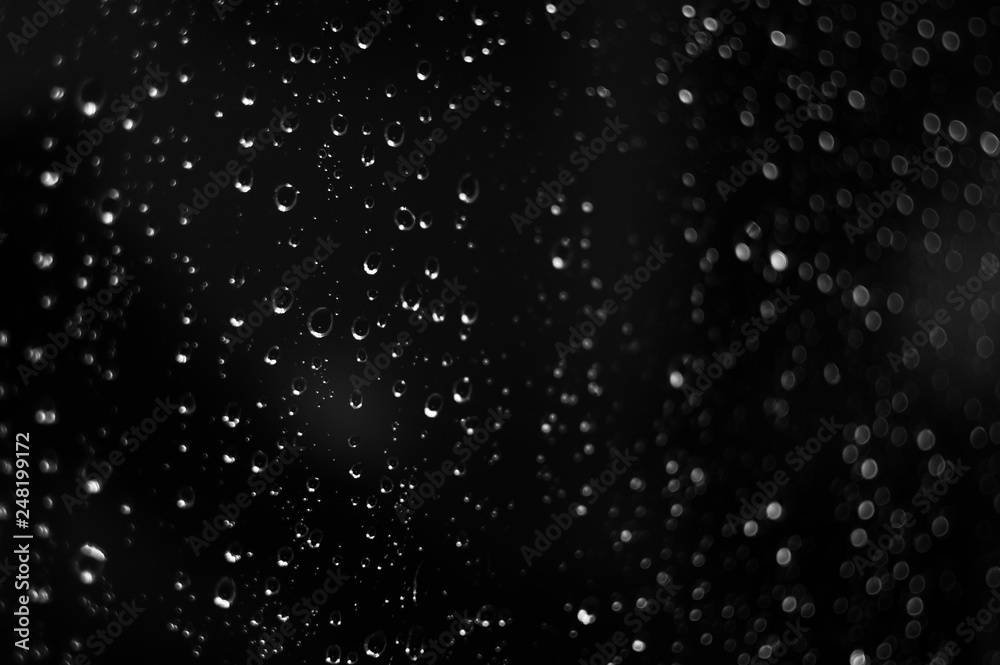 Droplets of water on black glass background