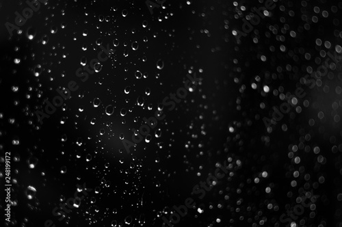 Droplets of water on black glass background © wowkwasyl