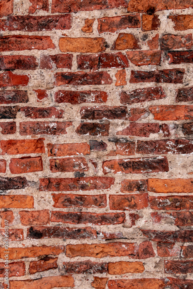 Naklejka premium Brick wall close-up photo. Vintage textured surface with old red brickwork