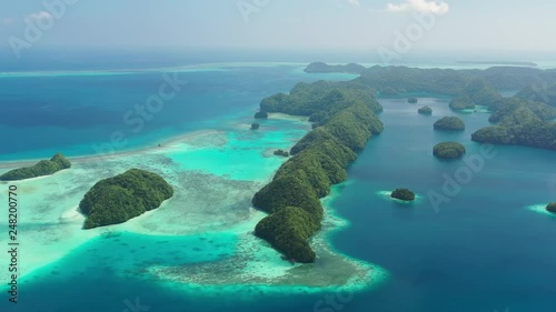 Aerial view of South Rock Islands (Chelbacheb), lush green islets around Mecherchar island, seascape with colorful coral reefs and tropical lagoons - landscape panorama of Micronesia from above, Palau