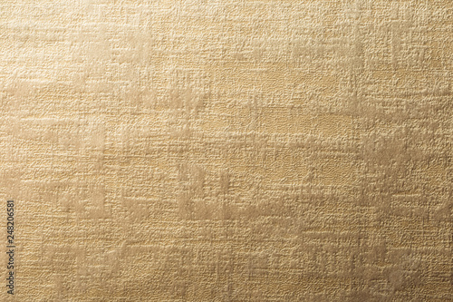 Gold surface of nap fabric, velours. Texture for background and design.