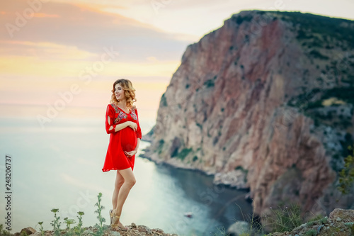 female travel nature scenery landscape concept of lady in red dress stay on edge of mountain top above south sea in summer bright weather with little wind on cape