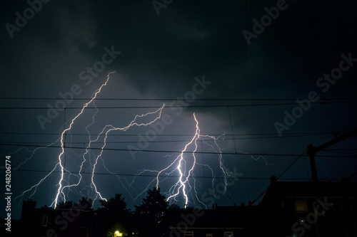 Branched lightning bolts over the city of Vlaardingen near Rotterdam, Netherlands photo