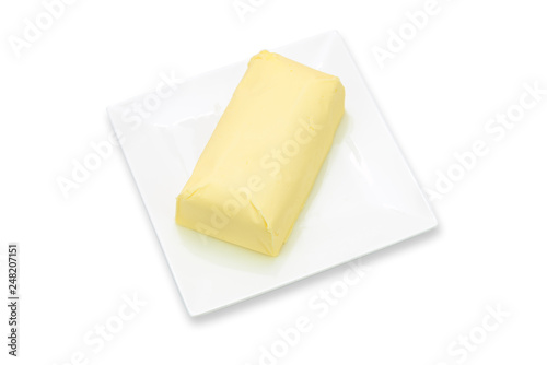 Piece of fresh organic butter on the plate isolated on a white background in close-up 