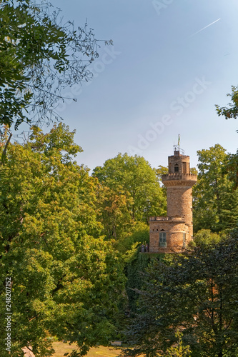 An old  historic defensive tower hidden between trees.