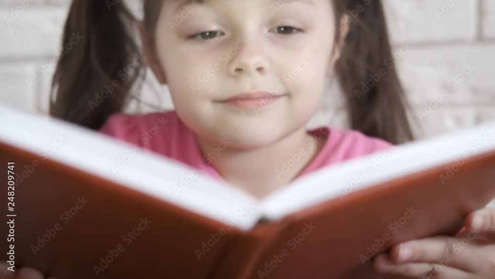 Happy child with a book. Portrait of a beautiful little girl with a book. Happy child with a book. Portrait of a beautiful little girl with a book.