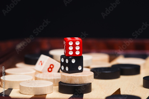 dice with chips on the backgammon Board.