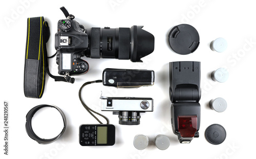 Different generations of cameras and a flash with a sync on a white background