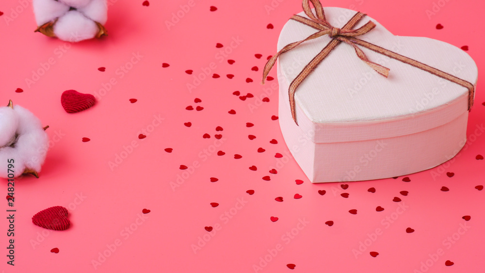 St. Valentine day background. Gift box with gold ribbon and lights on a pink background. Holiday background St. Valentine day background. Gift box with gold ribbon and lights on a pink background. Holiday background