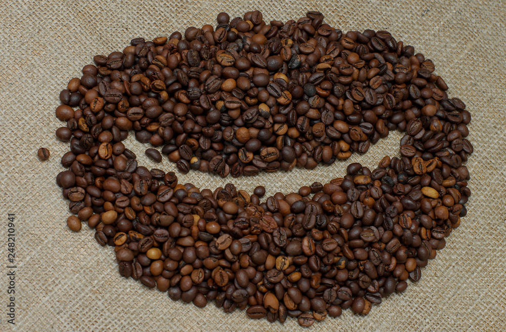 Coffee beans. Coffee beans on burlap in the form of coffee bean Coffee beans. Coffee beans on burlap in the form of coffee bean