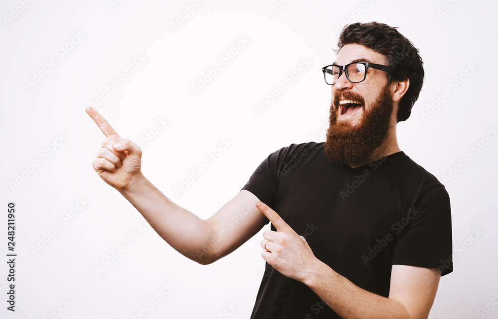 Photo of handsome fancy man wearing black tshirt having fun and pointing fingers away meaning