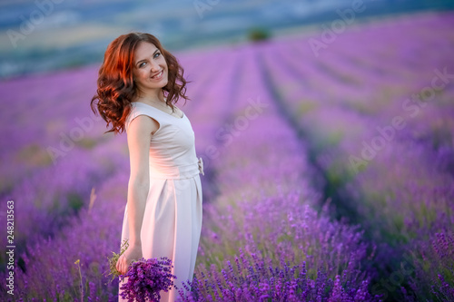 beautiful bride in luxurious wedding dress in purple lavender flowers. Fashion romantic stylish woman with violet bouquet. Alluring slim girl in sunset over lavenda waiting for groom - Provence France