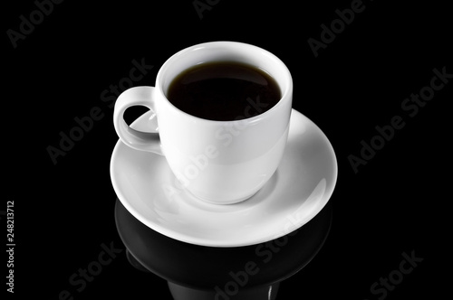 Cup of coffee on black reflective background.