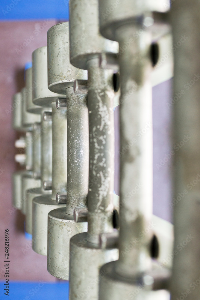 Rows of dumbbells in the gym. Dumbbell set. Many metal dumbbells on rack in sport fitness center. Top view Rows of dumbbells in the gym. Dumbbell set. Many metal dumbbells on rack in sport fitness center. Top view