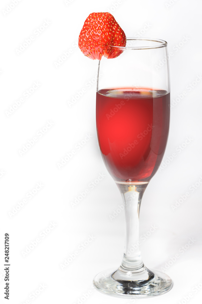 A glass of red wine with strawberries on a white background A glass of red wine with strawberries on a white background