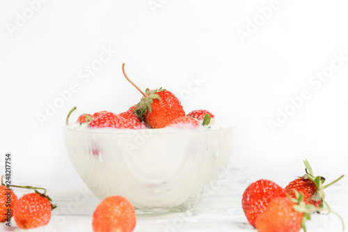 Fresh milk with homemade sweet strawberries on a white background.