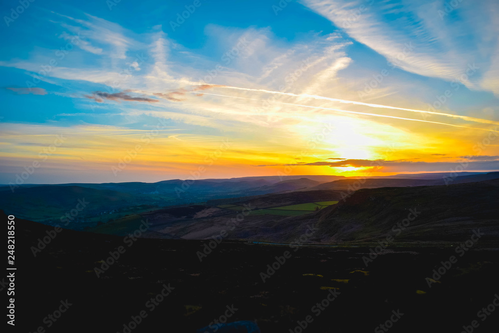 Amazing sunset overlooking fields and mountains in Peak District National Park Amazing sunset overlooking fields and mountains in Peak District National Park