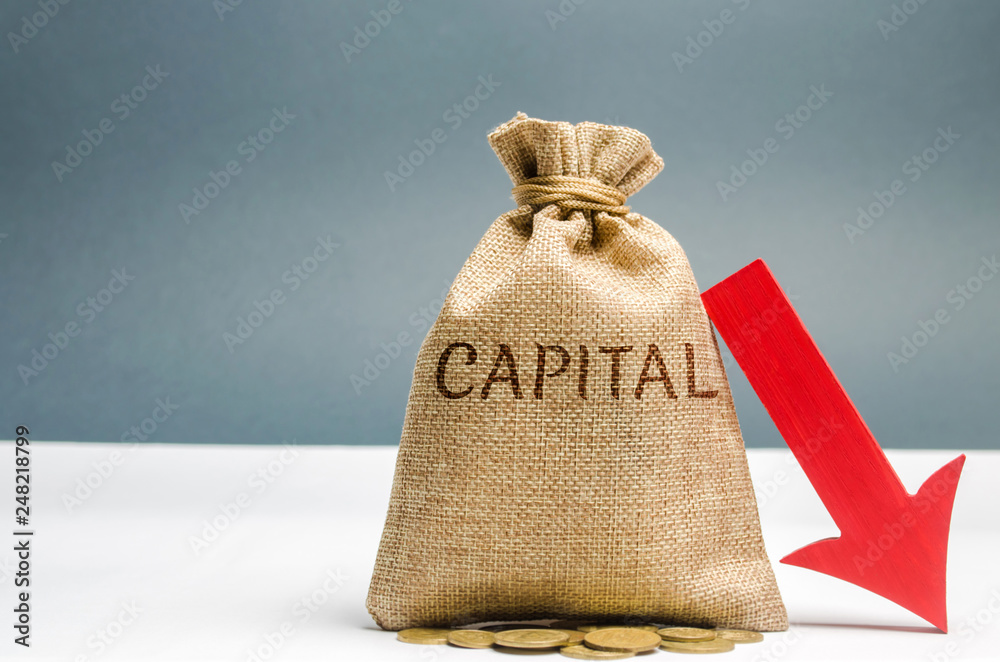 Money bag with the word Capital and arrow to down. Capital outflow. Currency devaluation. Falling stock quotes. Financial and economic crisis. Nationalization. High risks. Financial regulation