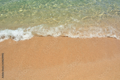 Clear transparent sea water, the wave and the sandy beach. For design postcard and calendar.