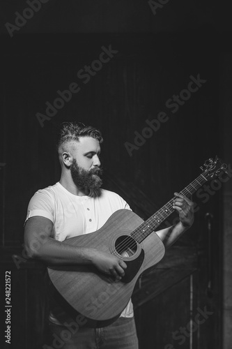 Cheerful bearded man greets by taking off a hat - studio shots