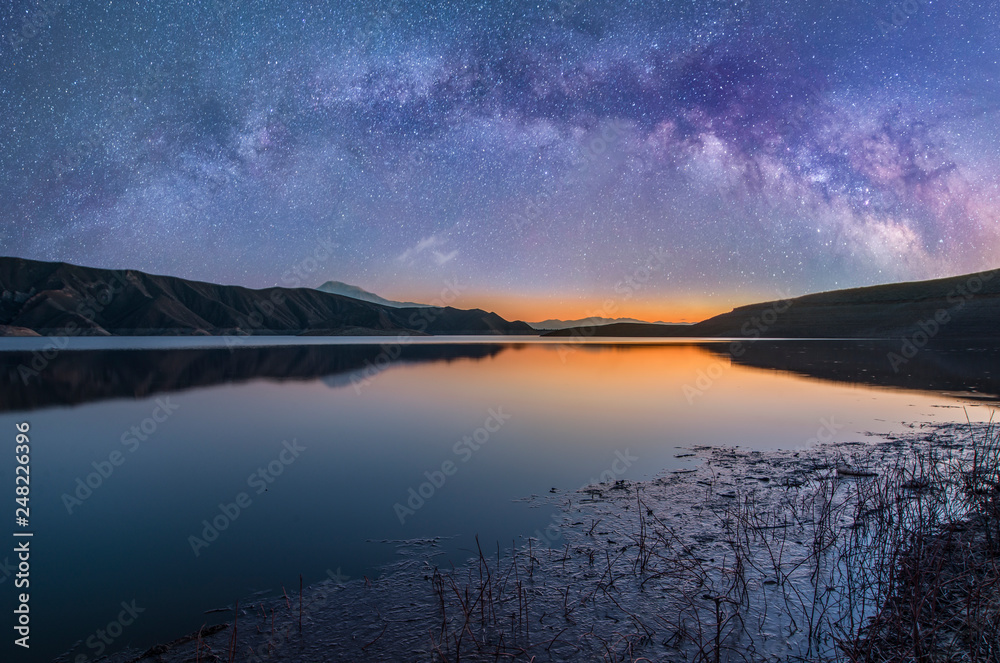 Colorful milky way galaxy over the lake and mountain. Beautiful night landscap