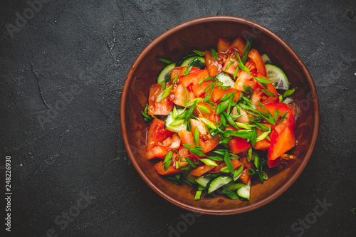 Healthy vegetable salad of fresh tomato, cucumber, onion, spinach, lettuce