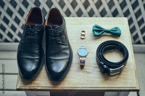 different accessories of a businessman for creating a style of a people lie on a wooden background