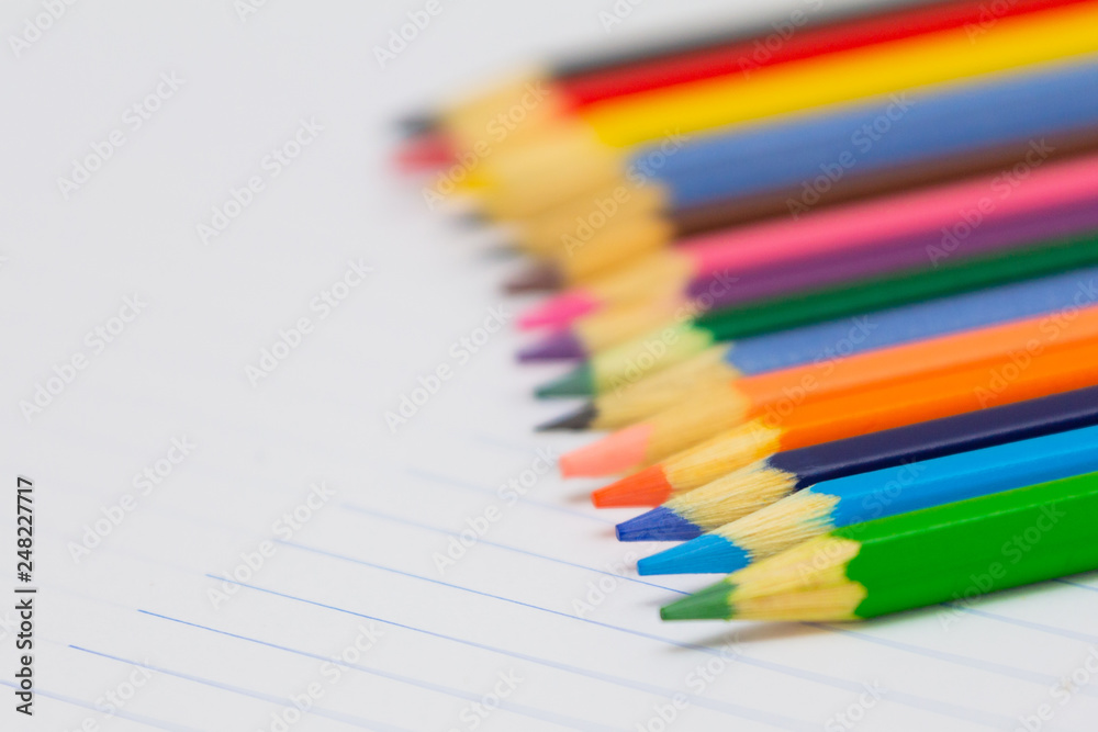Colored pencils with light background. Back to school. School supplies. Space for text Colored pencils with light background. Back to school. School supplies. Space for text