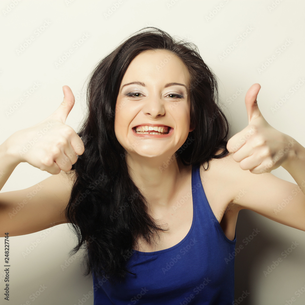 portrait of happy woman showing thumbs up portrait of happy woman showing thumbs up