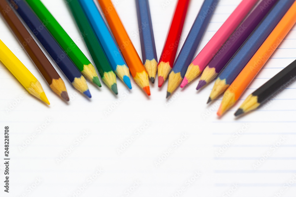 Colored pencils with light background. Back to school. School supplies. Space for text