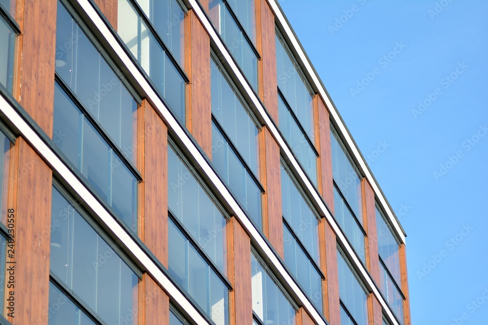 Modern apartment buildings on a sunny day with a blue sky. Facade of a modern apartment building Modern apartment buildings on a sunny day with a blue sky. Facade of a modern apartment building