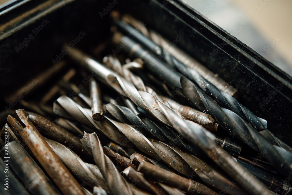 set of steel milling cutters for milling cutters in a rectangular box on the old black table, building old drills, work tools set of steel milling cutters for milling cutters in a rectangular box on the old black table, building old drills, work tools